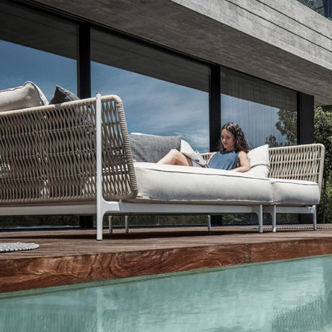 Woman lounging on Grand Weave sofa